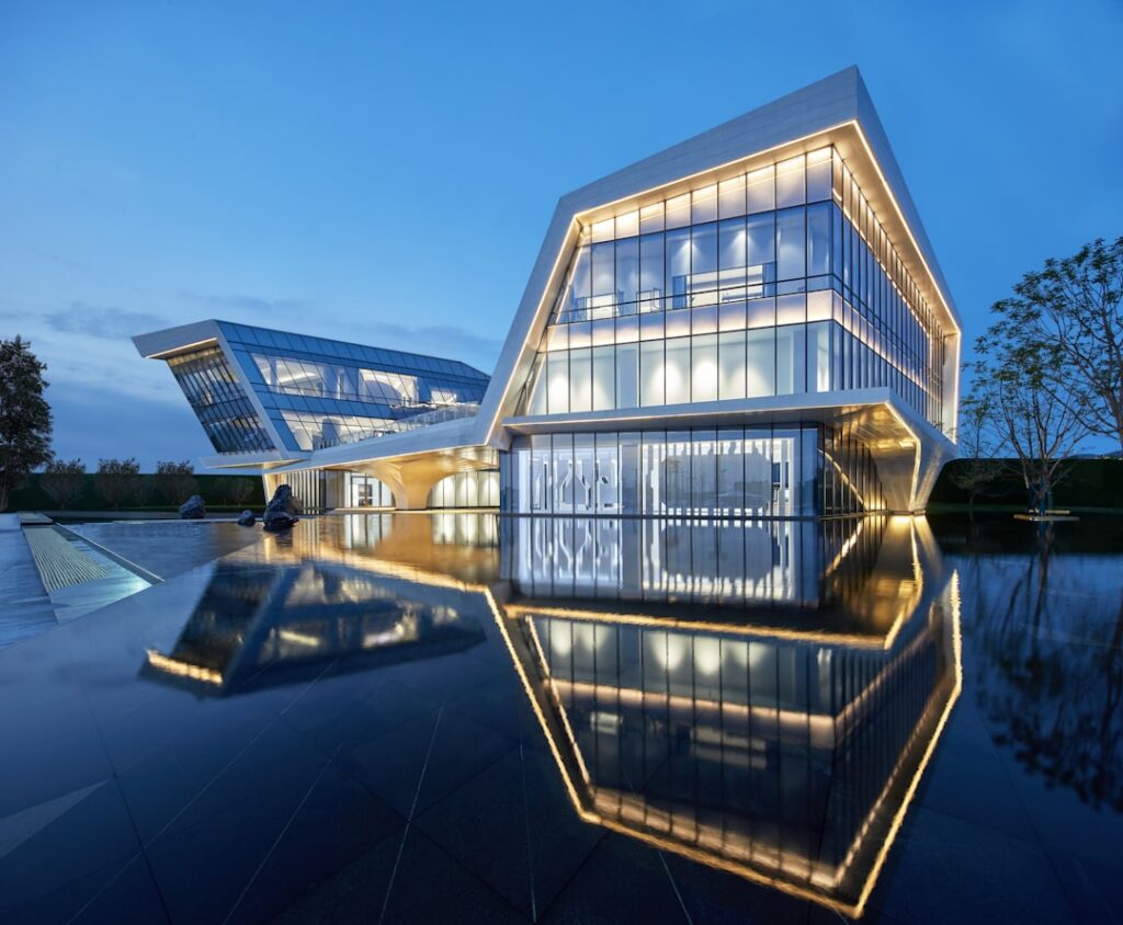 Design professional sketching a complex, glowing blueprint on a digital tablet in a modern, dark setting, representing the...