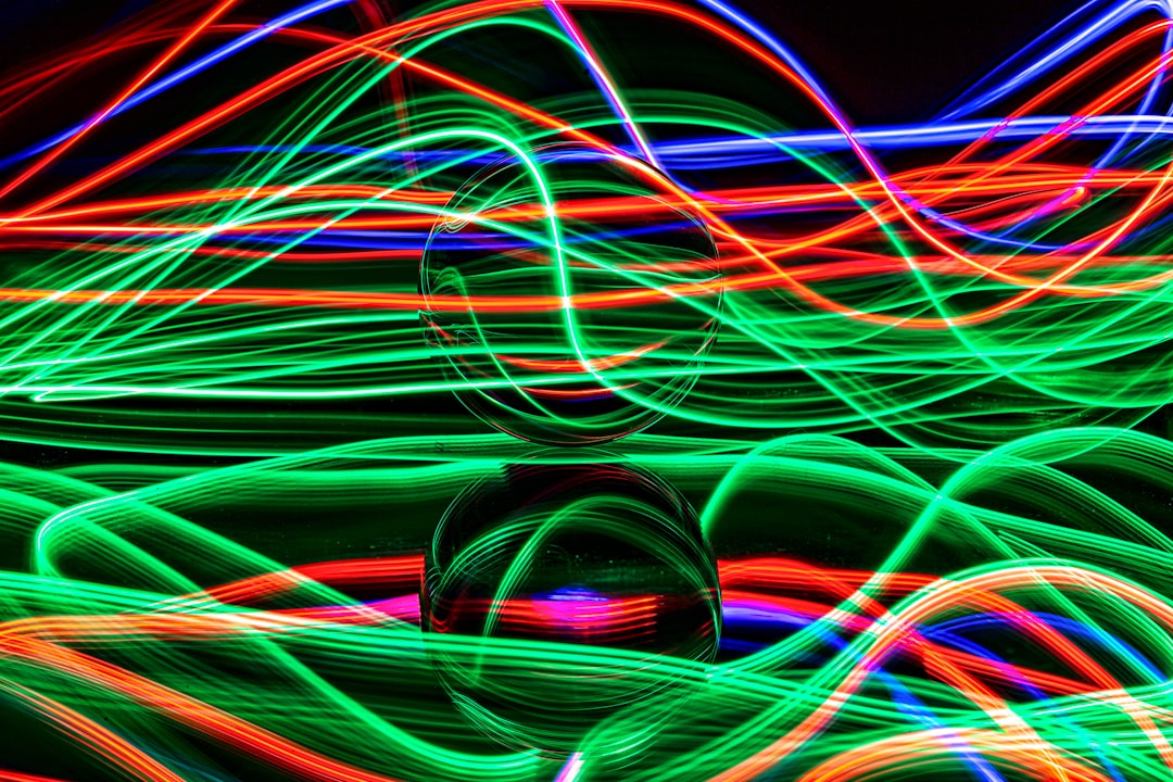 A close-up of a chaotic, tangled mess of glowing fiber optic cables in a dark environment, illustrating confused data pathways and system entropy.