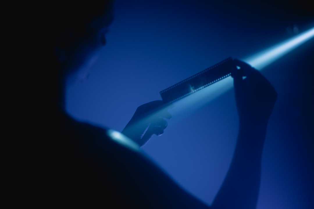 Close-up of a conductor's hands gracefully shaping streams of abstract light, symbolizing a leader's control and influence over their digital narrative.
