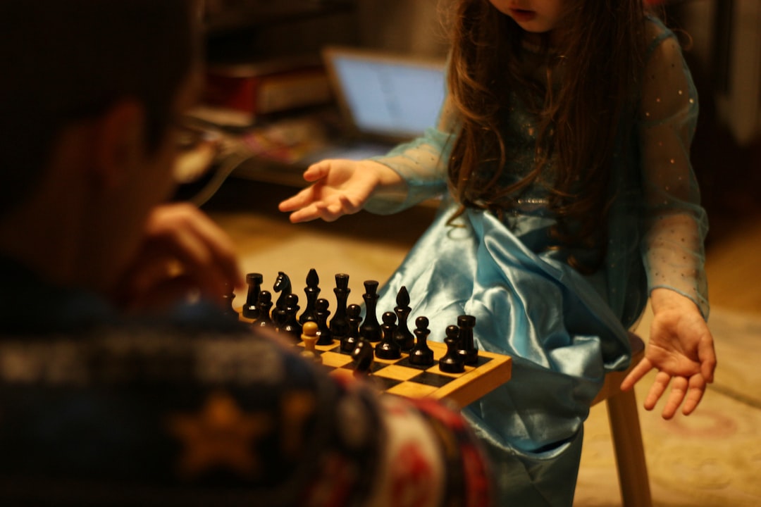 A focused professional contemplates their next move over a minimalist chess board in a modern office, illustrating strategic thinking in a competitive environment.