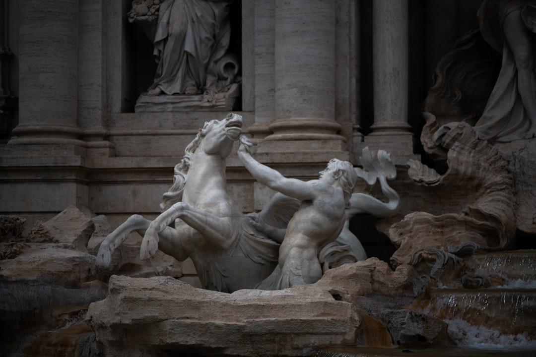 A minimalist, dramatically lit photo of a classical marble statue's face that is cracked and crumbling, representing the degradation of a once-perfect system.