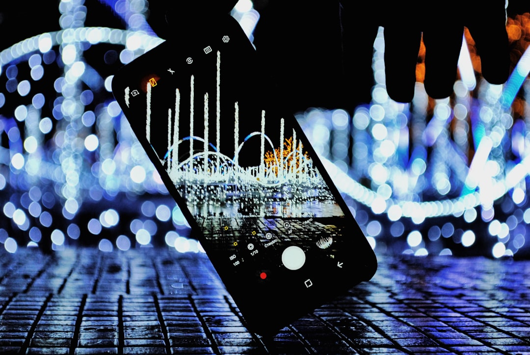 A minimalist shot of a smartphone with glowing, abstract lines connecting to it, visualizing an AI phone system at the center of a data network.
