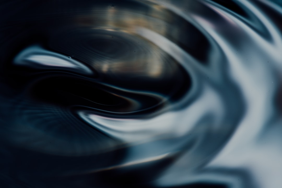 A modern, abstract image of reflective liquid metal flowing and adapting its shape, representing a fluid business strategy engineered for unpredictable change.