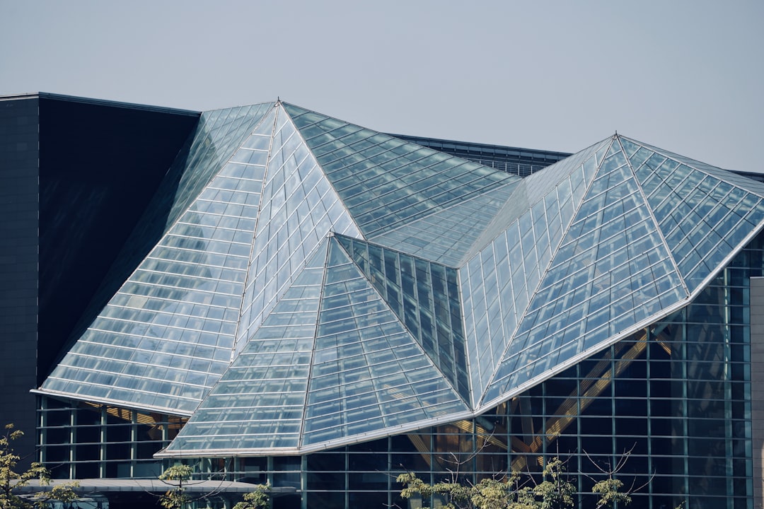 A modern, brightly lit photograph of a glass pyramid or funnel-like shape shattering into pieces, representing the end of old marketing models.