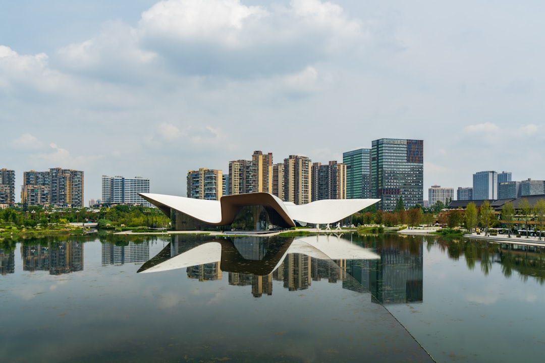 A person in a sharp business suit stands in a high-rise office, looking out at a vast, futuristic city skyline, embodying a leader's strategic vision for technology.