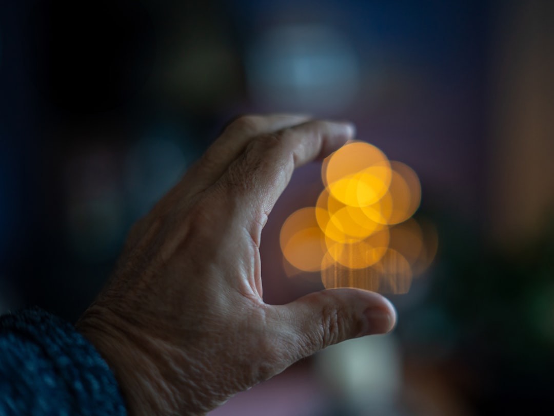A person's hand interacting with a floating, futuristic holographic interface, demonstrating the power of an AI-driven operating system.