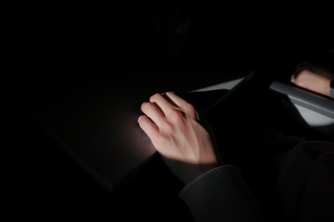 A person's hand reaches out to touch and manipulate a futuristic screen of glowing digital light, symbolizing control and proactive management of a brand's digital narrative.