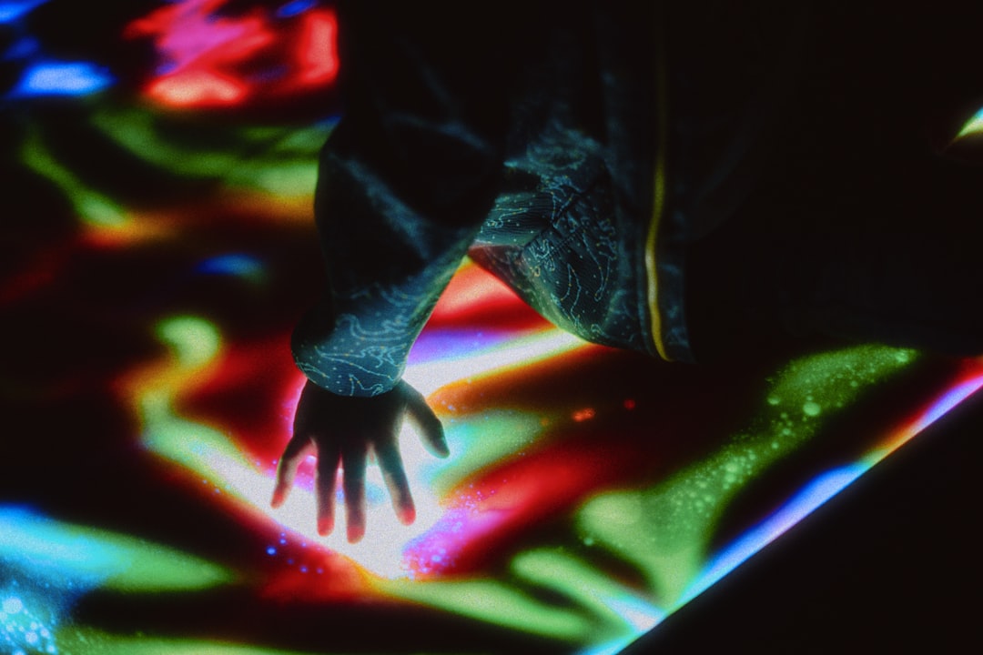 A professional's hand touching a futuristic holographic interface displaying complex data points, signifying the shift towards managing autonomous marketing systems.