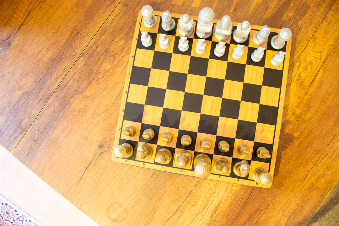 A sleek, modern robotic hand strategically moving a chess piece on a board, symbolizing the shift from simple instructions to autonomous, strategic AI actions.