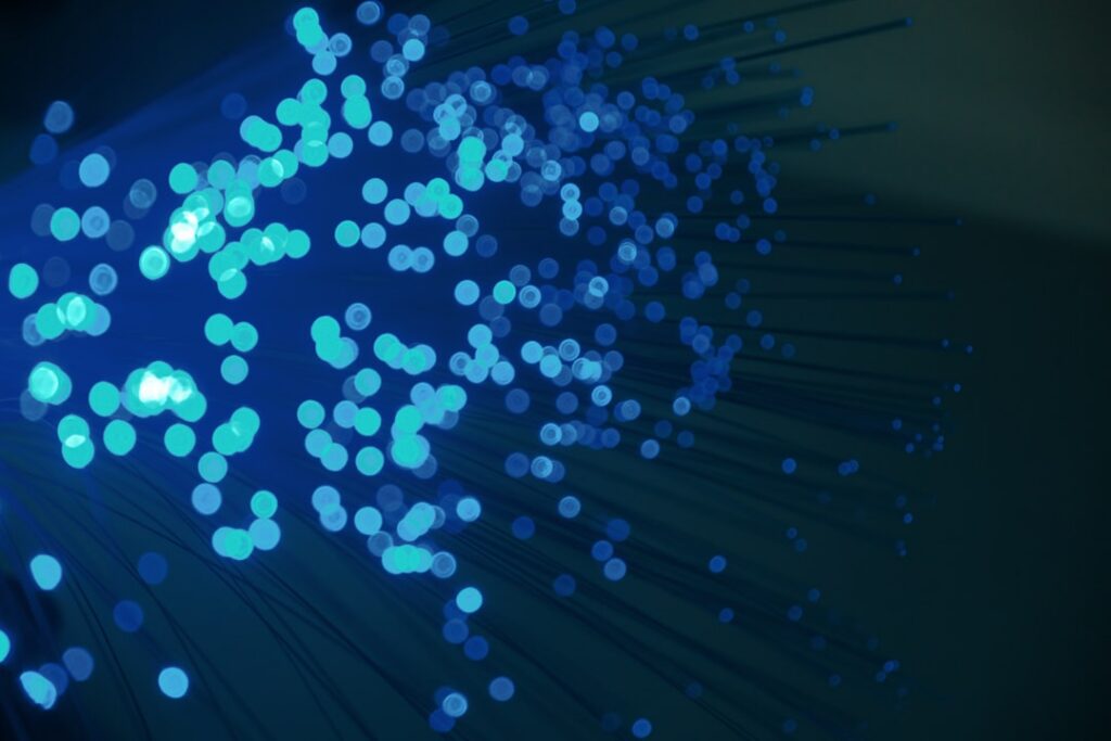 Abstract digital visualization of a glowing central core with lines of light radiating outwards, symbolizing a brand as th...