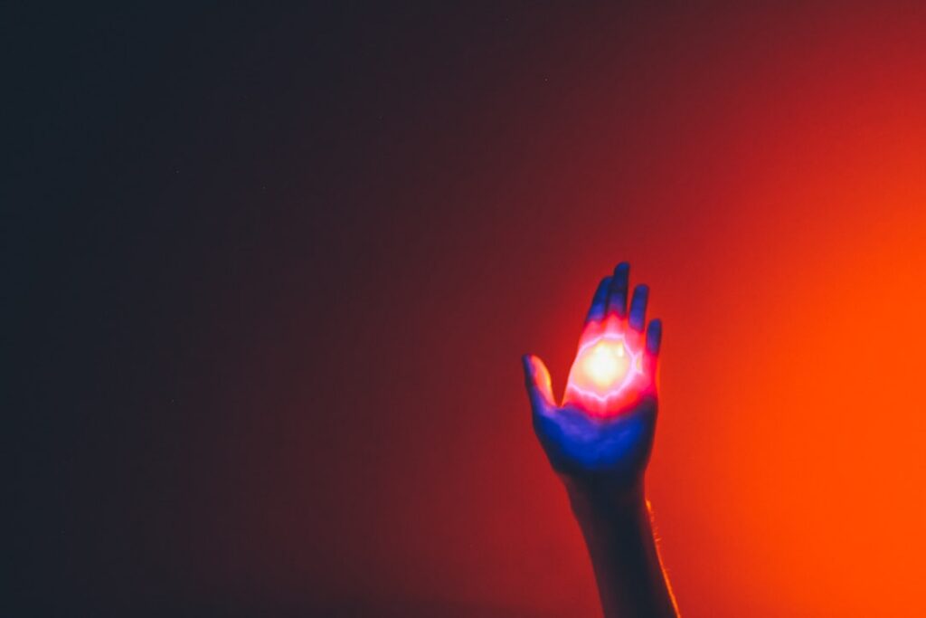 Person's hand reaches out to touch a futuristic, glowing digital interface, symbolizing the new point of contact between b...
