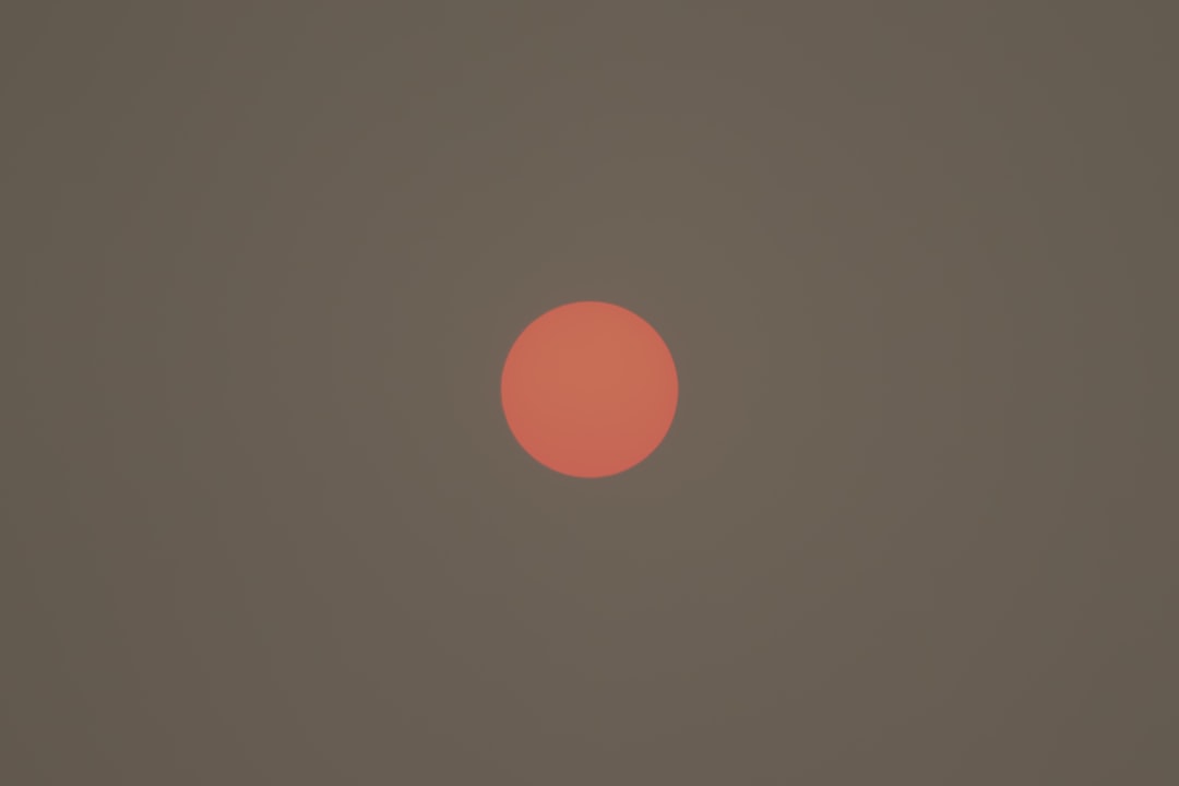A single, powerful sphere of light glowing in a dark, minimal environment, visually representing the core concept of 'Brand Singularity' and focusing marketing on a central AI.