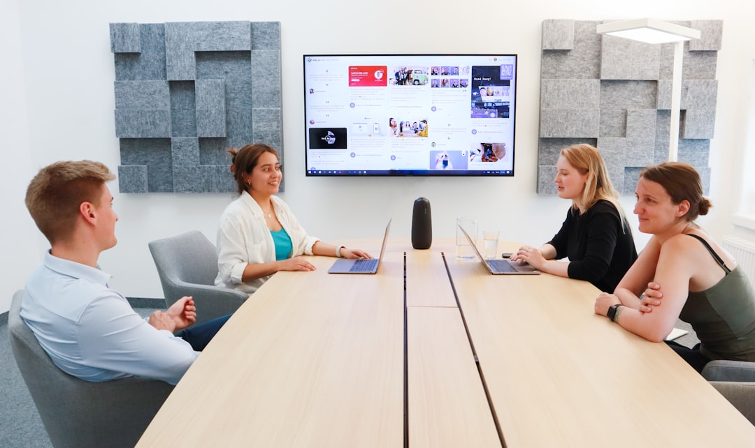 A sleek and modern minimalist meeting room with glass walls and professional furniture, suggesting a sophisticated, forward-thinking environment for AI-driven B2B deals.