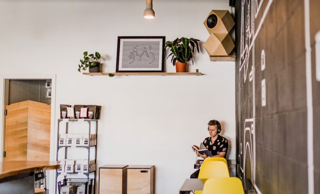 Sleek, modern robot sits at a minimalist desk in a bright office, symbolizing the concept of an AI workforce and algorithm...