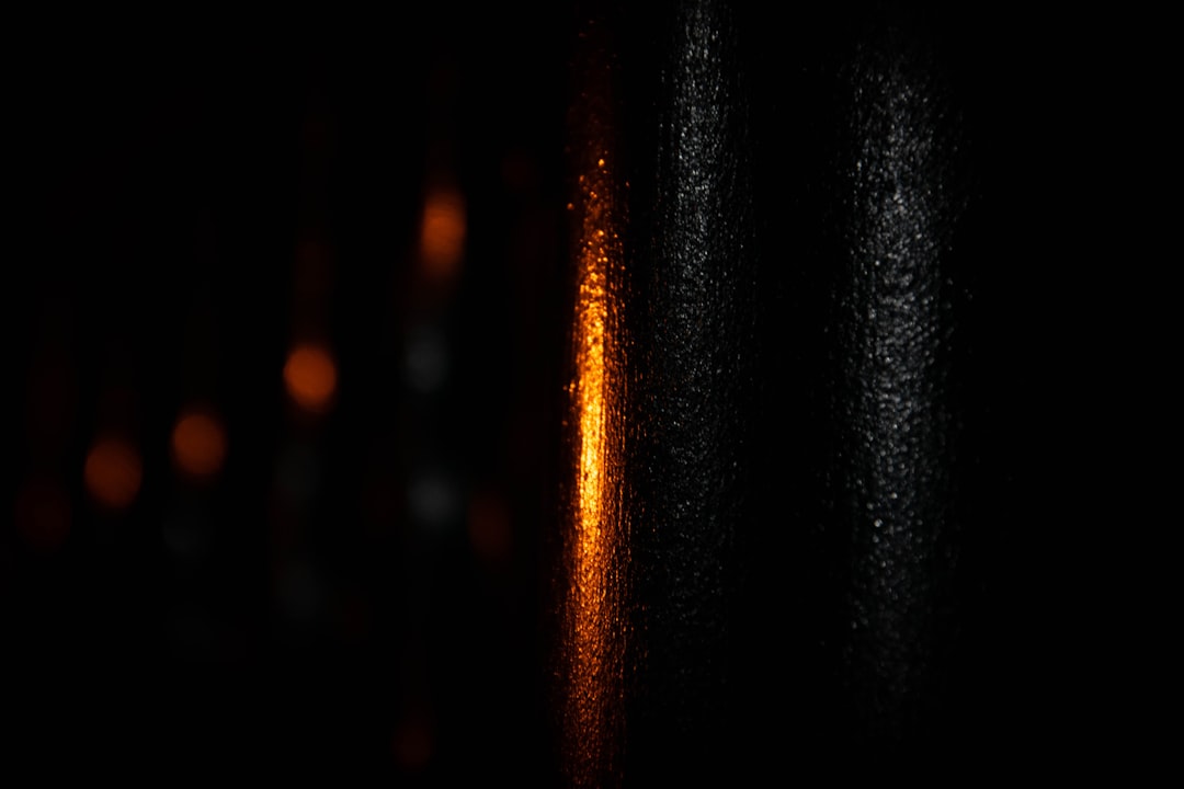 An abstract photo of a single, pure stream of light moving clearly through a dark, complex background, illustrating the concept of unique proprietary data as an antidote.