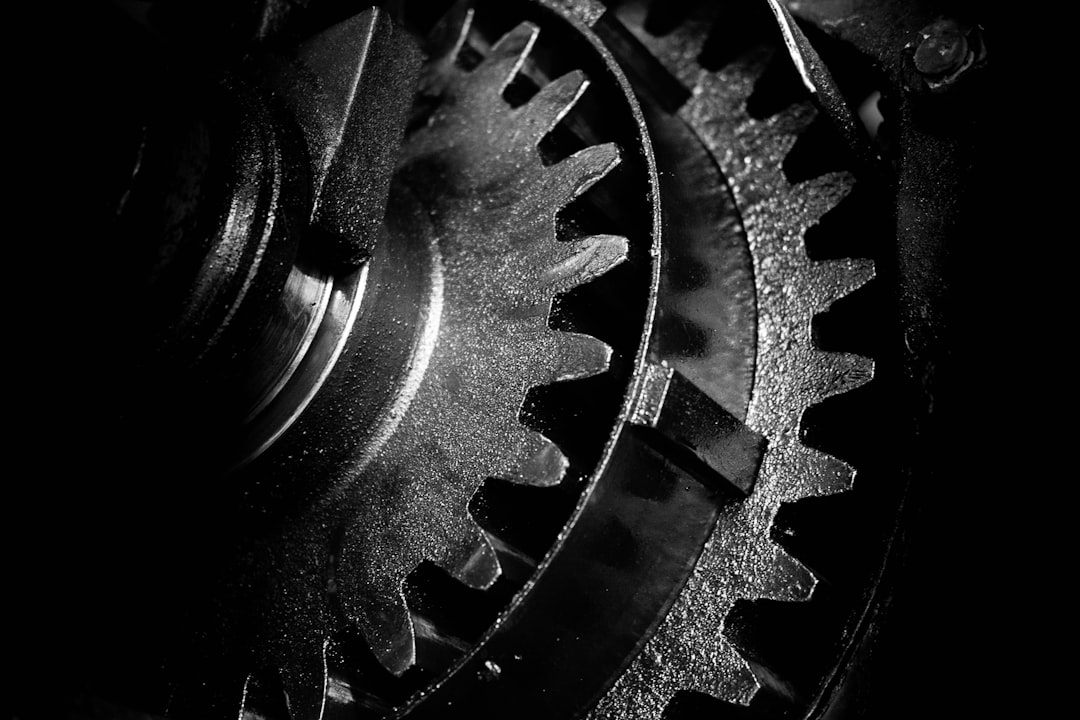 A clean, professional macro photograph of interlocking metal gears, symbolizing the precision and integrity of a self-verifying knowledge system.