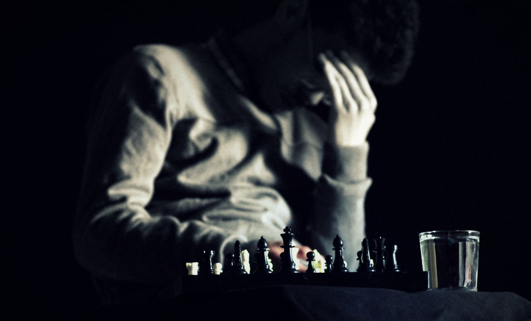 A close-up, cinematic shot of a hand strategically moving a transparent glass chess piece on a board, representing governance and calculated decision-making in a complex system.