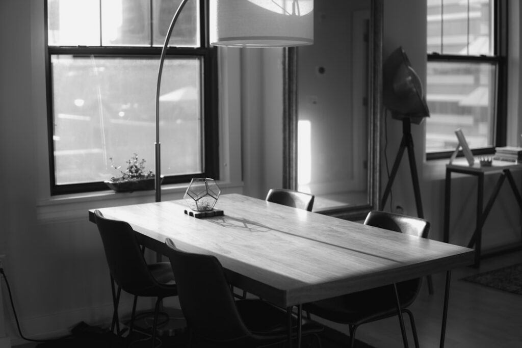 Detailed architectural blueprint spread out on a sleek, modern desk in a well-lit office, symbolizing strategic planning a...