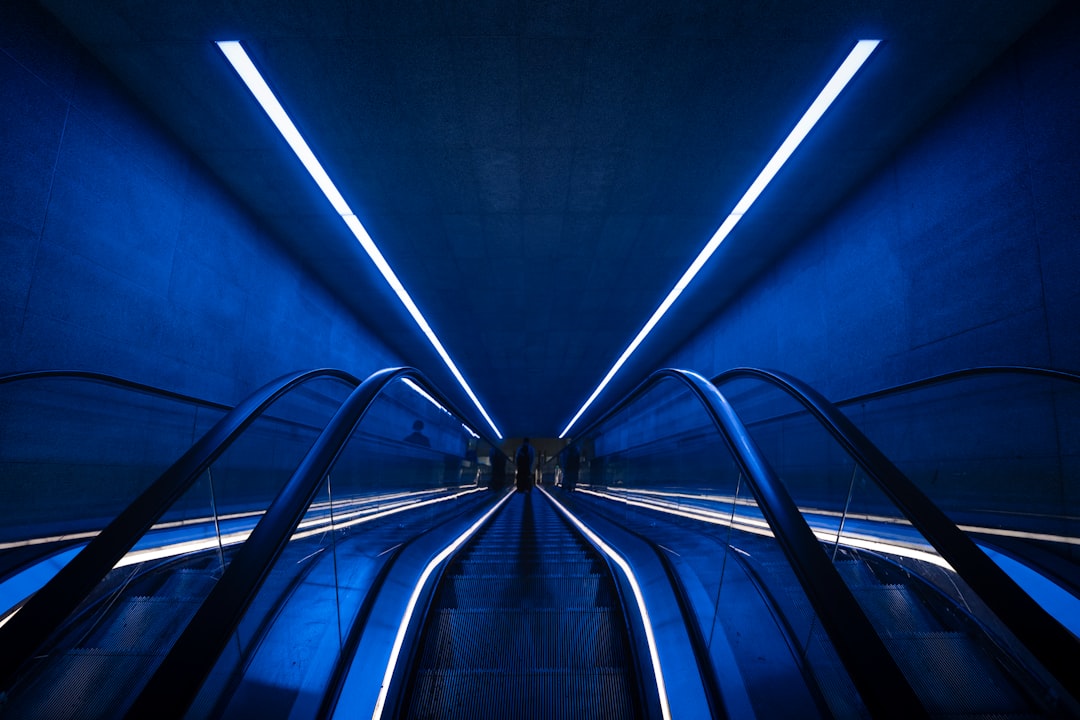 A secure, modern data center with rows of server racks illuminated by cool blue lights, representing a fortified and resilient business infrastructure against digital threats.