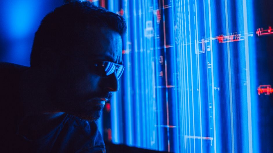 A business professional in a modern, minimalist office interacting with a futuristic holographic data interface, symbolizing autonomous revenue generation.