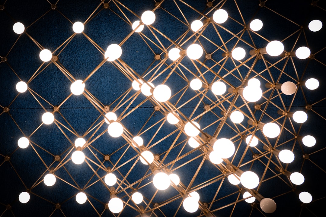 A minimal, bright image of interconnected glowing nodes on a clean white background, representing the structure of an algorithmic immunity system.