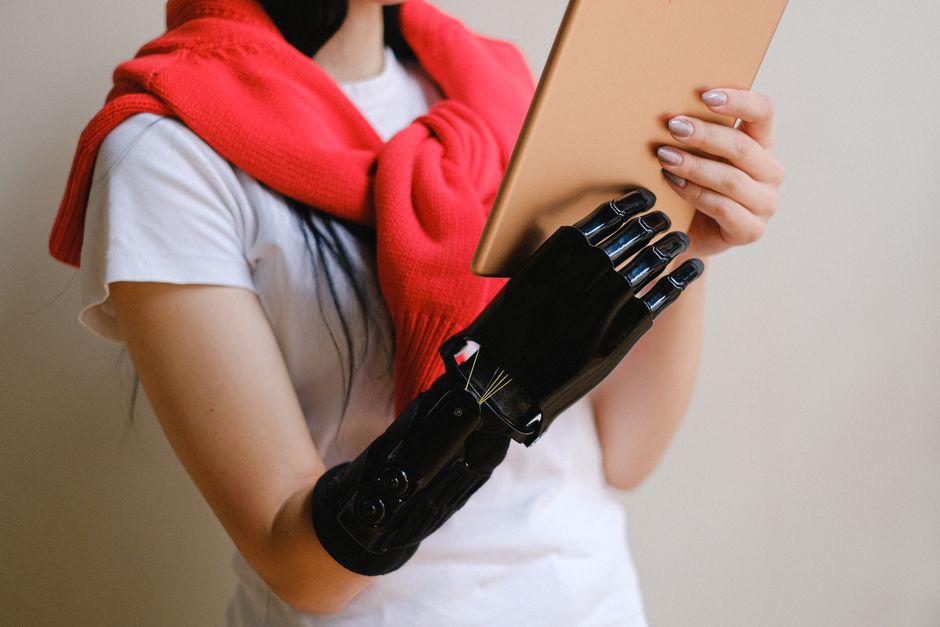 A sleek, modern robotic hand interacting with a glowing digital interface, illustrating the new paradigm of brand interaction within an AI-driven world.