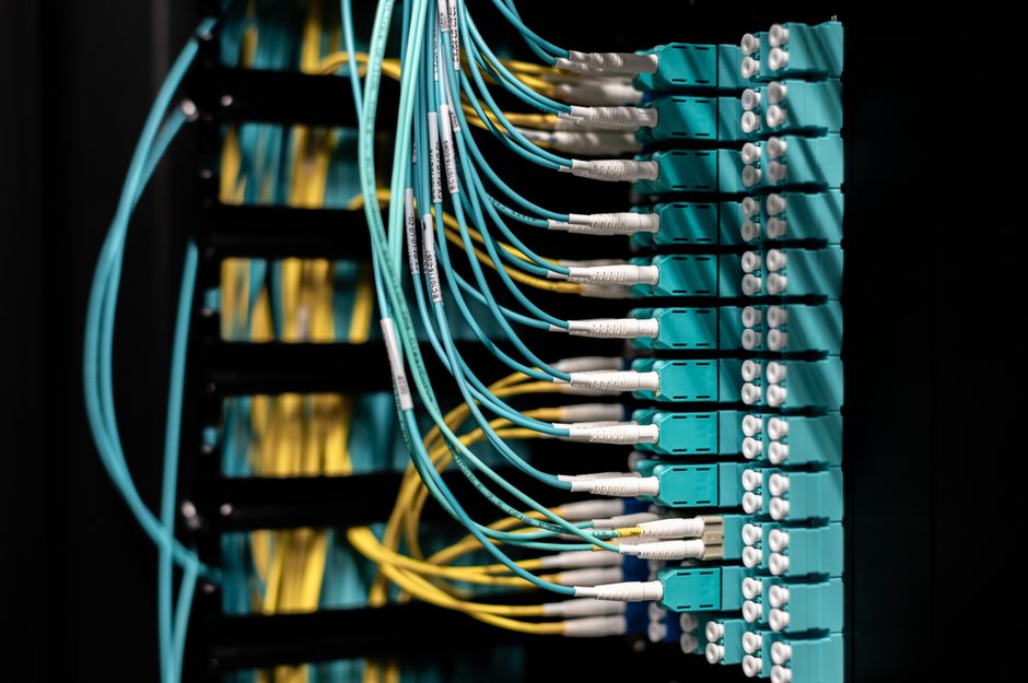 A close-up shot of a tangled but organized server rack with several key network cables unplugged, illustrating the critical disconnect in failed AI projects.