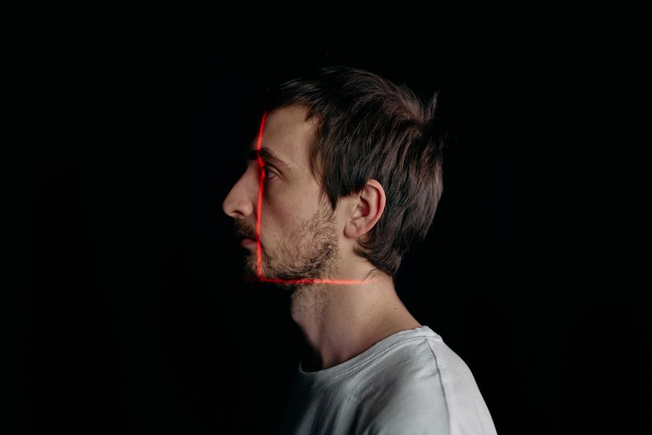 A minimalist silhouette of a human profile constructed from flowing lines of digital light against a dark, modern background, symbolizing an identity synthesized by AI.