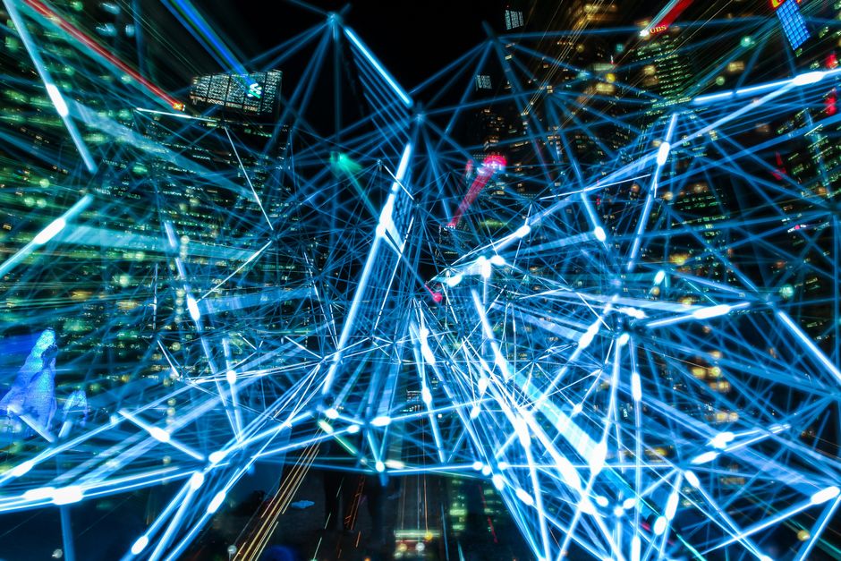 A network of glowing, interconnected cubes forming an orderly structure against a dark background, illustrating the idea of architecting a unified digital identity.
